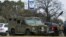 An armored law enforcement vehicle is seen in the area where a man has reportedly taken people hostage at a synagogue during services that were being streamed live, in Colleyville, Texas, Jan. 15, 2022. 