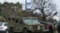 An armored law enforcement vehicle is seen in the area where a man has reportedly taken people hostage at a synagogue during services that were being streamed live, in Colleyville, Texas, Jan. 15, 2022. 