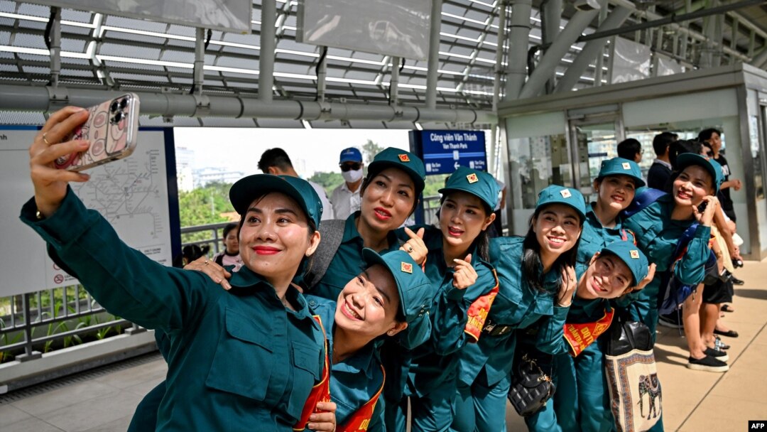 Soldiers take a selfie on the platform at a metro station in Ho Chi Minh City on Dec. 22, 2024.