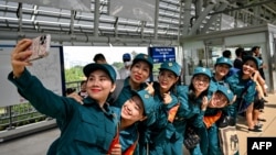 Soldiers take a selfie on the platform at a metro station in Ho Chi Minh City on Dec. 22, 2024.