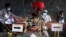 FILE - A voter casts her ballot in Ngozi, Burundi, May 20, 2020, amid concerns over political violence and COVID-19 infection.
