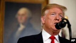 FILE - President Donald Trump speaks about the partial government shutdown, immigration and border security in the Diplomatic Reception Room of the White House, in Washington, Jan. 19, 2019. 