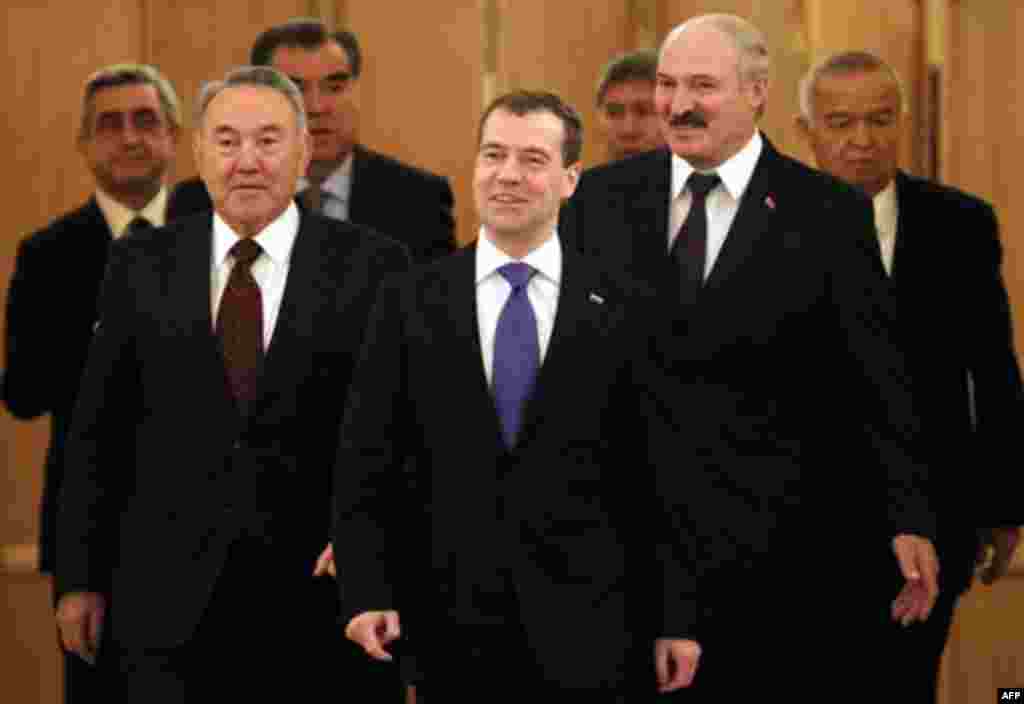 Russian President Dmitry Medvedev, center, flanked by Belarusian President Alexander Lukashenko, right, and Kazakh President Nursultan Nazarbayev, left, enter a hall to attend a summit of the Collective Security Treaty Organization in the Kremlin in Mosc