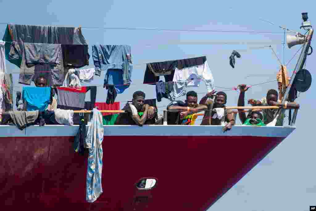Migrants dry their clothes aboard a tourist boat some 20 kilometers from Malta.