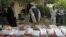 FILE  - Afghan police display seized heroine at a police station in Jalalabad.  