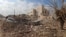FILE - Destruction is seen around the Udai hospital following airstrikes on the town of Saraqeb in Syria's northwestern province of Idlib, Jan. 29, 2018. Syrian troops had been advancing on Idlib as part of a fierce offensive launched in late December with Russian backing.