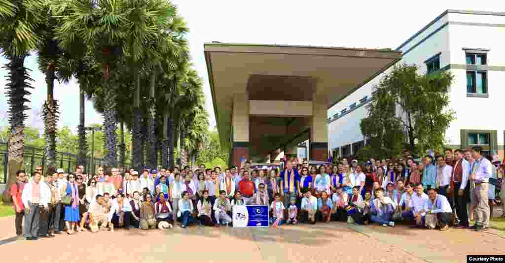 U.S. Ambassador W. Patrick Murphy poses in a photo with his staff and country development partners in front of the U.S. Embassy in Phnom Penh, Cambodia. (Photo courtesy of U.S. Embassy in Cambodia) 