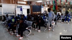 Guinean migrants wait at the airport before being deported to Guinea, in Misrata, Libya, Dec. 27, 2017.