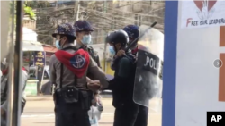 Police arrest Associated Press (AP) photographer Thein Zaw posing for a photo during his coverage of demonstrations by protesters against the military coup in Yangon, a day before he was arrested.