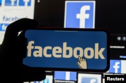 FILE - The Facebook logo is displayed on a mobile phone in this picture illustration.