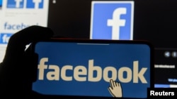 FILE - The Facebook logo is displayed on a mobile phone in this picture illustration.