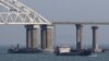 A vessel sails past a bridge connecting Russia with the Crimean Peninsula across the Kerch Strait on November 26, 2018.(Pavel Rebrov/Reuters) 