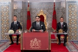 In this photo provided by the Moroccan News Agency (MAP), Morocco's King Mohammed VI, accompanied by his son Crown Prince Moulay Hassan and brother Prince Moulay Rashid addresses the Nation at the Royal Palace in Tetouan, July 29, 2019.…