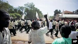 A southern Sudanese woman chants with pro-independence activists as they march through the southern capital of Juba, 09 Sep 2010