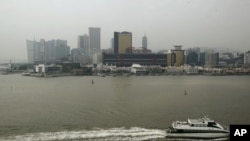 FILE - A ferry sails across the Casino Sands' Macau, Dec.19, 2009. 
