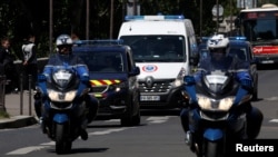 A police convoy believed to be carrying Rwandan genocide fugitive Felicien Kabuga arrives at the Paris courthouse where Kabuga is due to appear for an arraignment hearing, France, May 19, 2020.