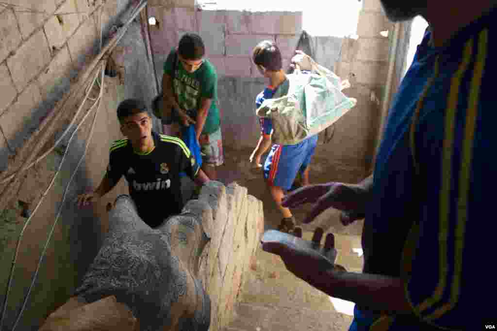 Players leaving Majdi Adam’s home. The football teams train weekly and regularly play games against other local squads. (John Owens for VOA)