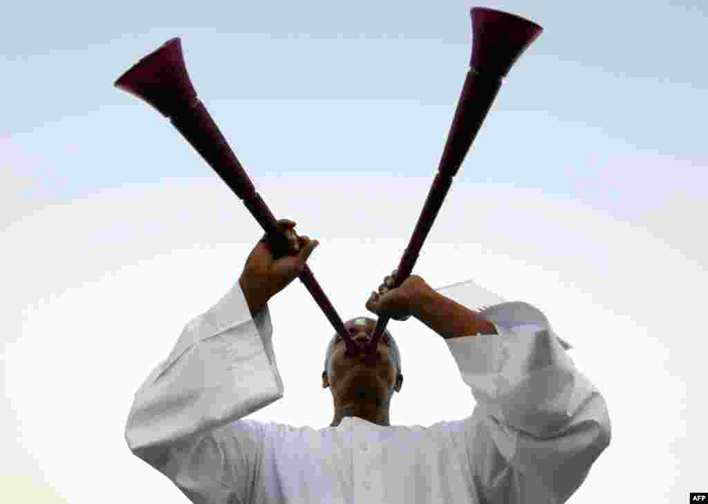 A Qatari soccer fan blows a vuvuzela before the announcement of the hosts for the 2022 World Cup, in Souq Waqif December 2. (Fadi Al-Assaad/Reuters)