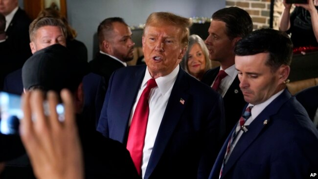 Former President Donald Trump greets supporters during a stop at the Front Street Pub & Eatery, Dec. 5, 2023, in Davenport, Iowa.