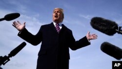 President Donald Trump talks to the media before he boards Air Force One for a trip to Los Angeles to attend a campaign fundraiser, Feb. 18, 2020, at Andrews Air Force Base, Maryland. 