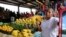 FILE - Maria Trinidad, from Guerrero, Mexico, runs a fruit and vegetable stand at Sunny Flea Market in Houston. (R. Taylor/VOA News)