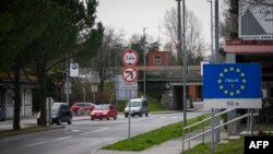 Cars exit and enter Slovenia at one of the border crossings in Nova Gorica, on the Slovenian-Italian border, March 10, 2020. 