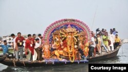 Immersion ceremoney of an idol of goddess Durga the Buriganga river in Dhaka 
