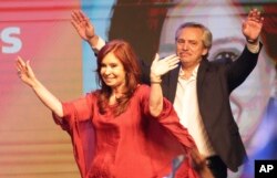 Peronist presidential candidate Alberto Fernández, behind, and running mate, former President Cristina Fernández, celebrate after the election results in Buenos Aires, Argentina, Oct. 27, 2019.