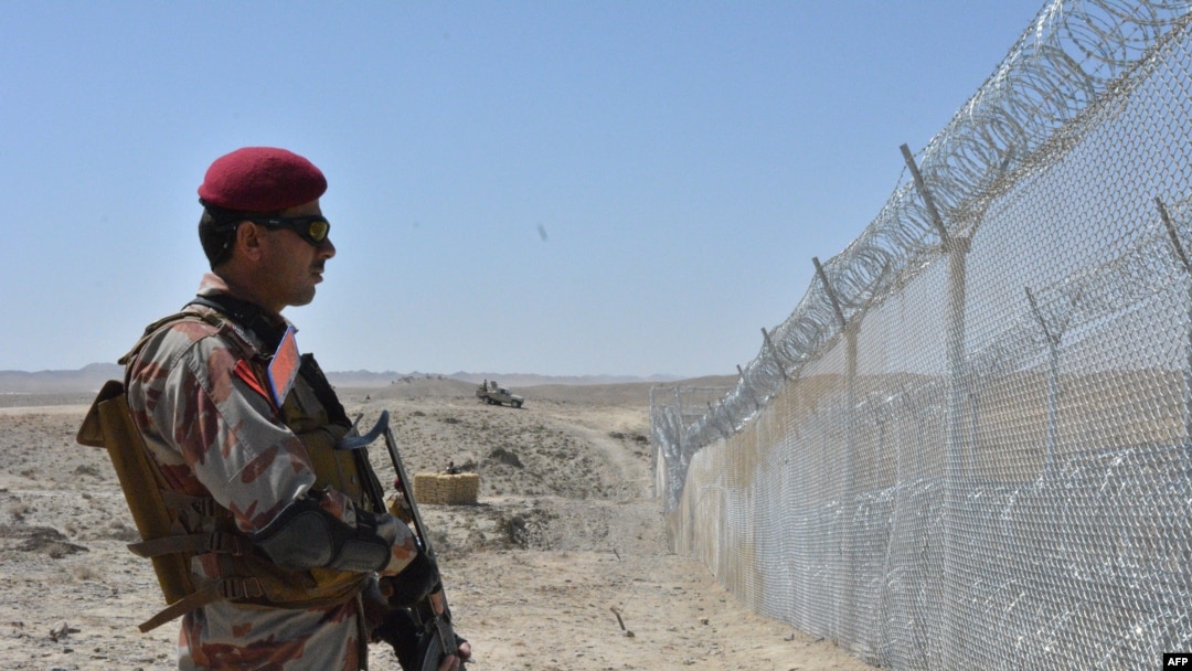 FILE - A Pakistani army soldier stands guard along with border fence at the Pakistan-Afghanistan border near the Punjpai area of Quetta in Balochistan, May 8, 2018.