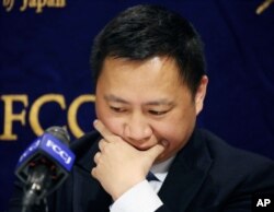 FILE - Veteran Chinese dissident Wang Dan pauses during a press conference in Tokyo, Japan, May 29, 2019.