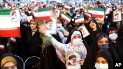 Supporters of Iranian president-elect Ebrahim Raisi celebrate after he won the presidential election in Tehran, Iran, June 19, 2021.