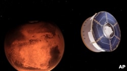 This illustration provided by NASA depicts the Mars 2020 spacecraft carrying the Perseverance rover as it approaches Mars. 