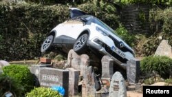 A car is pictured at a cemetary following heavy rainfalls in Dernau, Germany.
