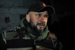 Andriy Antonenko, suspected of involvement in the killing of journalist Pavel Sheremet, is seen outside his house as law enforcement officers prepare to search his apartment, Kyiv, Ukraine, Dec. 12, 2019.