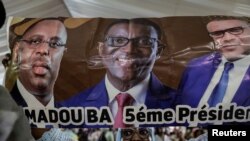 FILE— A supporter of Senegalese presidential candidate Amadou Ba holds his poster during his campaign rally in Guediawaye on the outskirts of Dakar, Senegal March 10, 2024.