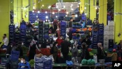 People shop at the local market in Istanbul, Turkey, a few hours before the start of the latest lockdown to help protect from the spread of the coronavirus.