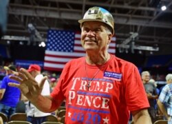 FILE - Trump supporter John Berta of Oceana, W.Va., a retired coal miner, waves to the crowd at a rally with President Donald Trump, Aug. 21, 2018, at the Civic Center in Charleston W.Va.