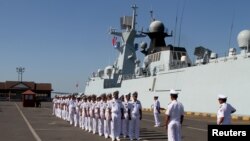 FILE - Cambodian navy officials attend a ceremony after conducting an exercise with Chinese naval officers in Preah Sihanouk province, Cambodia, Feb. 26, 2016.