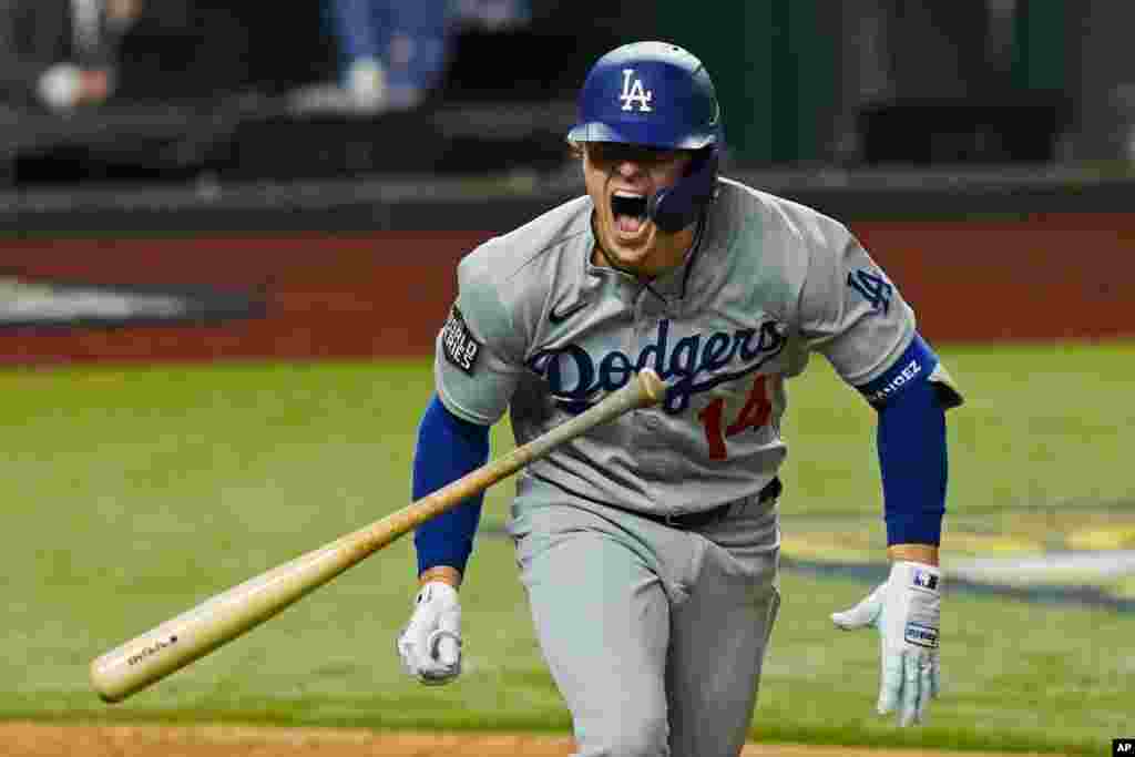 Los Angeles Dodgers&#39; Enrique Hernandez celebrates a RBI-double against the Tampa Bay Rays during the sixth inning in Game 4 of the baseball World Series, Oct. 24, 2020, in Arlington, Texas.