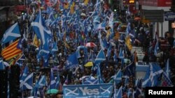 FILE - Demonstrators march for Scottish Independence through Glasgow City center in Scotland, Jan. 11, 2020.
