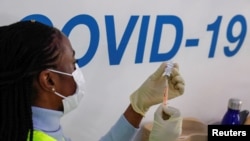 A dose of AstraZeneca vaccine is prepared at COVID-19 vaccination center in the Odeon Luxe Cinema in Maidstone, Britain, Feb. 10, 2021. 