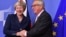 European Commission President Jean-Claude Juncker, right, greets British Prime Minister Theresa May at EU headquarters in Brussels, Nov. 24, 2018. 