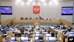 In this photo provided by the State Duma, deputies attend a session at the State Duma, the Lower House of the Russian Parliament in Moscow, Russia, May 19, 2021. 