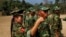 In this photo taken on Monday, Feb. 13, 2012, recruits of the Kachin Independence Army, one of the country's largest armed ethnic groups, receive training from a female instructor, left, at a military camp near Laiza.