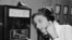 As coins slide down before her eyes, a German woman uses a new long distance dial telephone for public booths, July 17,1957.(AP Photo)