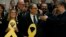 Newly appointed Catalan president Quim Torra, center, holds a yellow ribbon in support of Catalonian politicians who have been jailed on charges of sedition, at the end of a parliamentary vote session in Barcelona, Spain, May 14, 2018. 