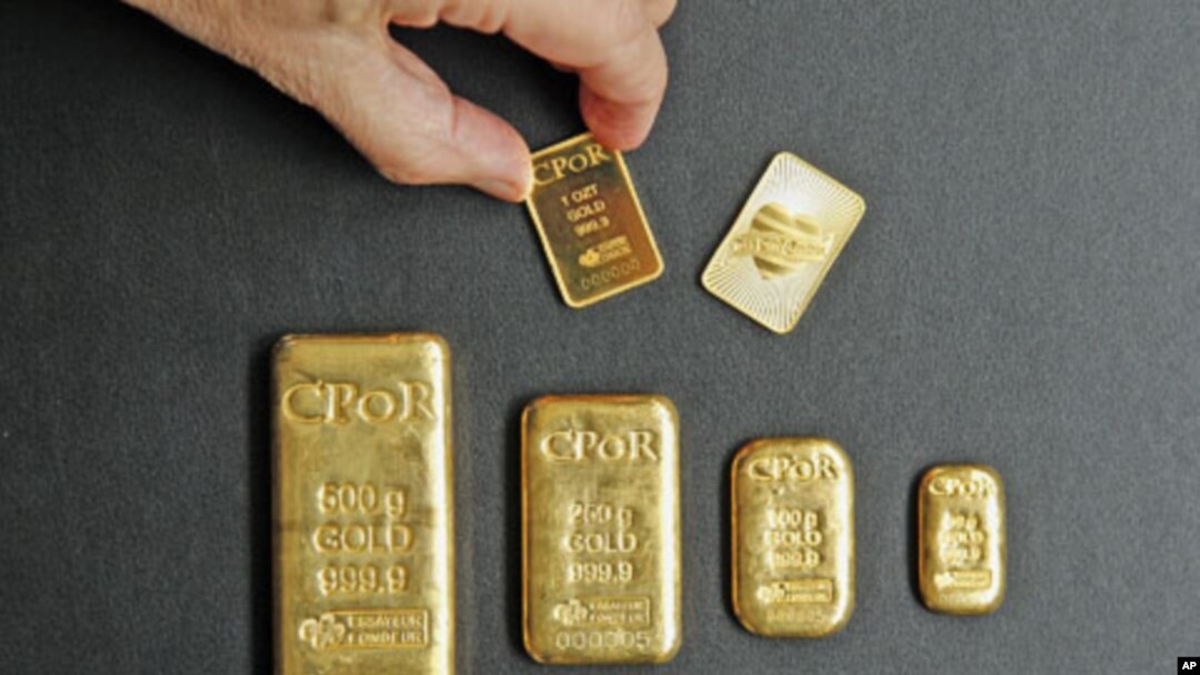 A one-ounce gold bar [top R] designed by fashion designer Jean Paul Gaultier is displayed with gold bars weighing between one ounce and 500 grams in an office of French gold supplier CPoR Devises company in Paris, October 10, 2011.