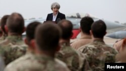 Britain's Prime Minister Theresa May speaks to the troops at RAF Akrotiri, one of two military bases Britain maintains on the east Mediterranean island of Cyprus, Dec. 22, 2017. 