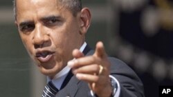 President Barack Obama gestures after a statement in the Rose Garden of the White House in Washington, where he urged Congress to pass a federal highway bill, August 31, 2011.