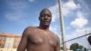 A Mundari wrestler stands with ash on his body before the "Wrestling for Peace" tournament at Juba Stadium in South Sudan's capital, April 16, 2016. (J. Patinkin/VOA)